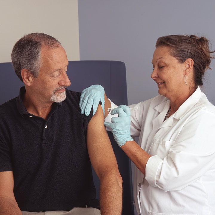 man getting shot from nurse